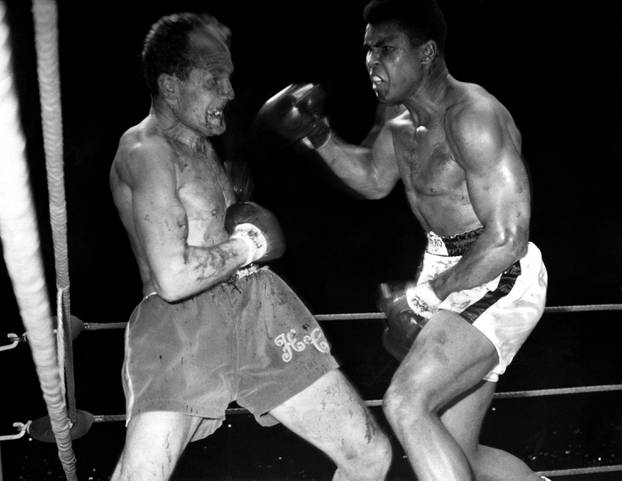  World Heavyweight Champion Muhammad Ali, (formerly Cassius Clay), and challenger Henry Cooper fight at Highbury Stadium, London