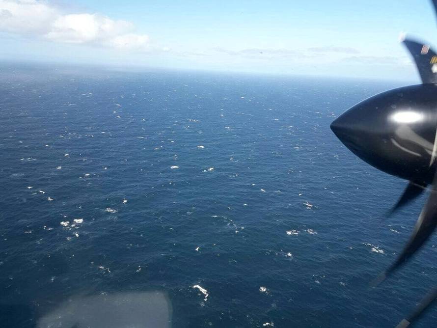 An Argentine Navy airplane is seen as it flies over the Atlantic Ocean during the search for the ARA San Juan submarine missing at sea