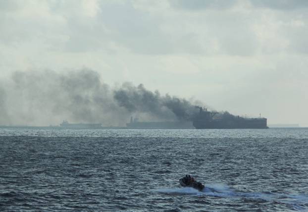 Rescue teams reach oil tankers on fire off the Singaporean island of Pedra Branca