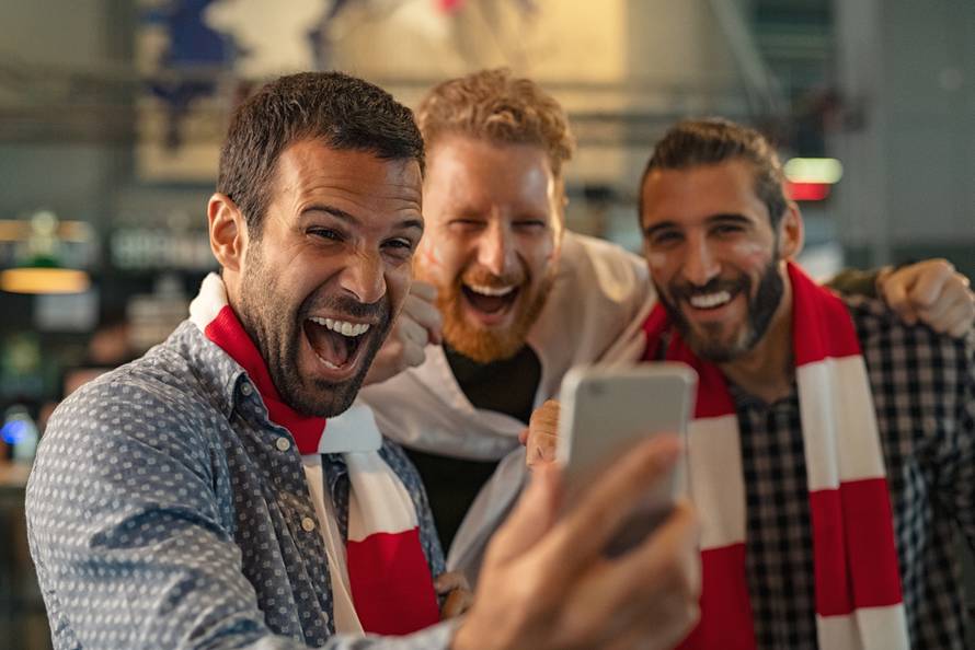 Excited,Men,Watching,Football,In,Streaming,On,Smartphone.,Football,Fans