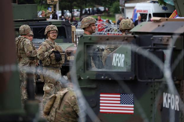 U.S. KFOR soldiers, under NATO, stand guard near a municipal office in Leposavic