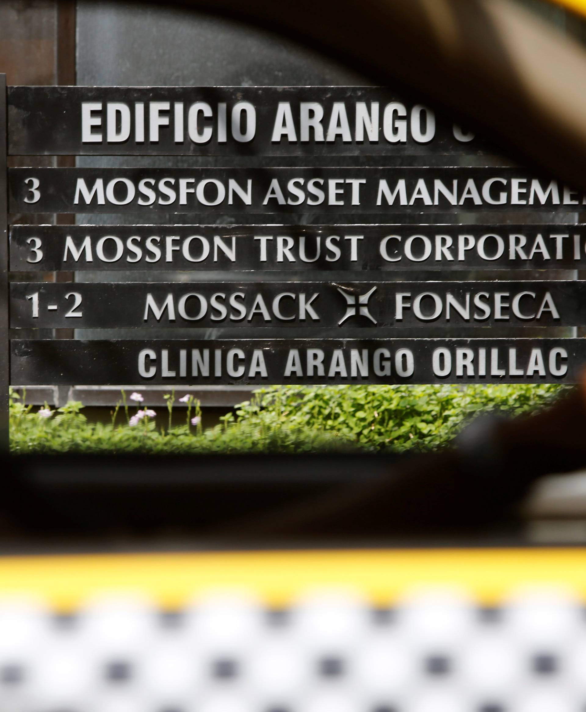 A taxi pass a company list showing the Mossack Fonseca law firm at the Arango Orillac Building in Panama City