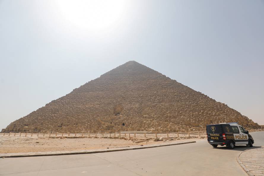A police car is parked near the Great Pyramids, Giza, on the outskirts of Cairo, as the coronavirus disease (COVID-19) outbreak continues