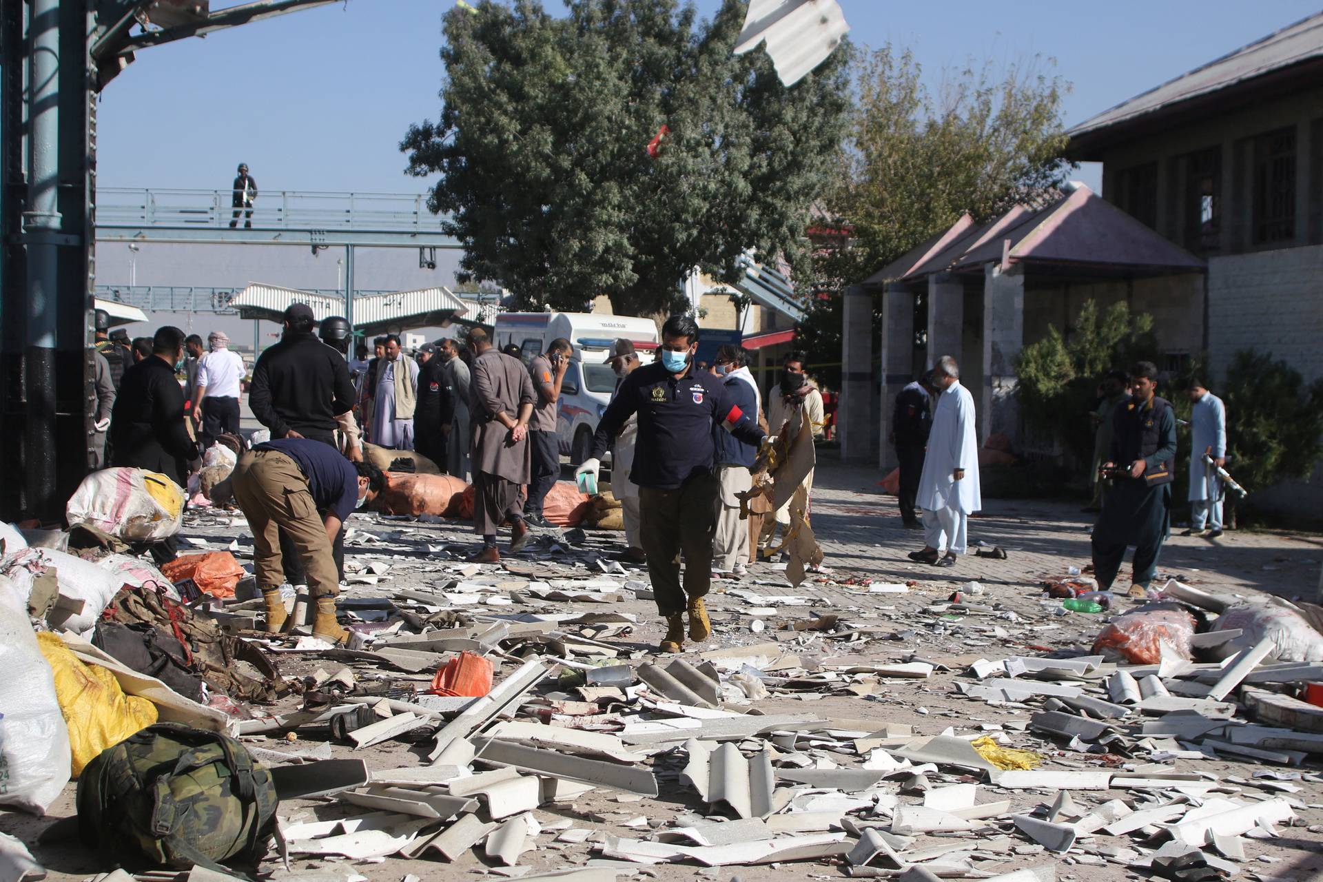 Police officer surveys the site amid the debris after a bomb blast at a railway station in Quetta