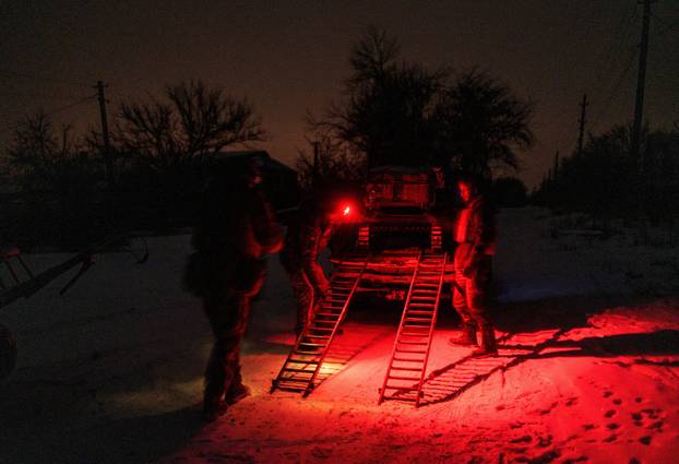 Ukrainian servicemen operate an unmanned ground vehicle fit for delivery missions on the frontline in Donetsk region