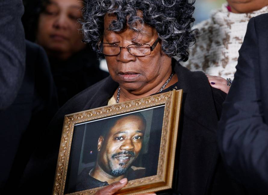 Judy Scott looks over a photo of her son Walter Scott during a news conference after former police officer Michael Slager was sentenced to 20 years in prison, in Charleston