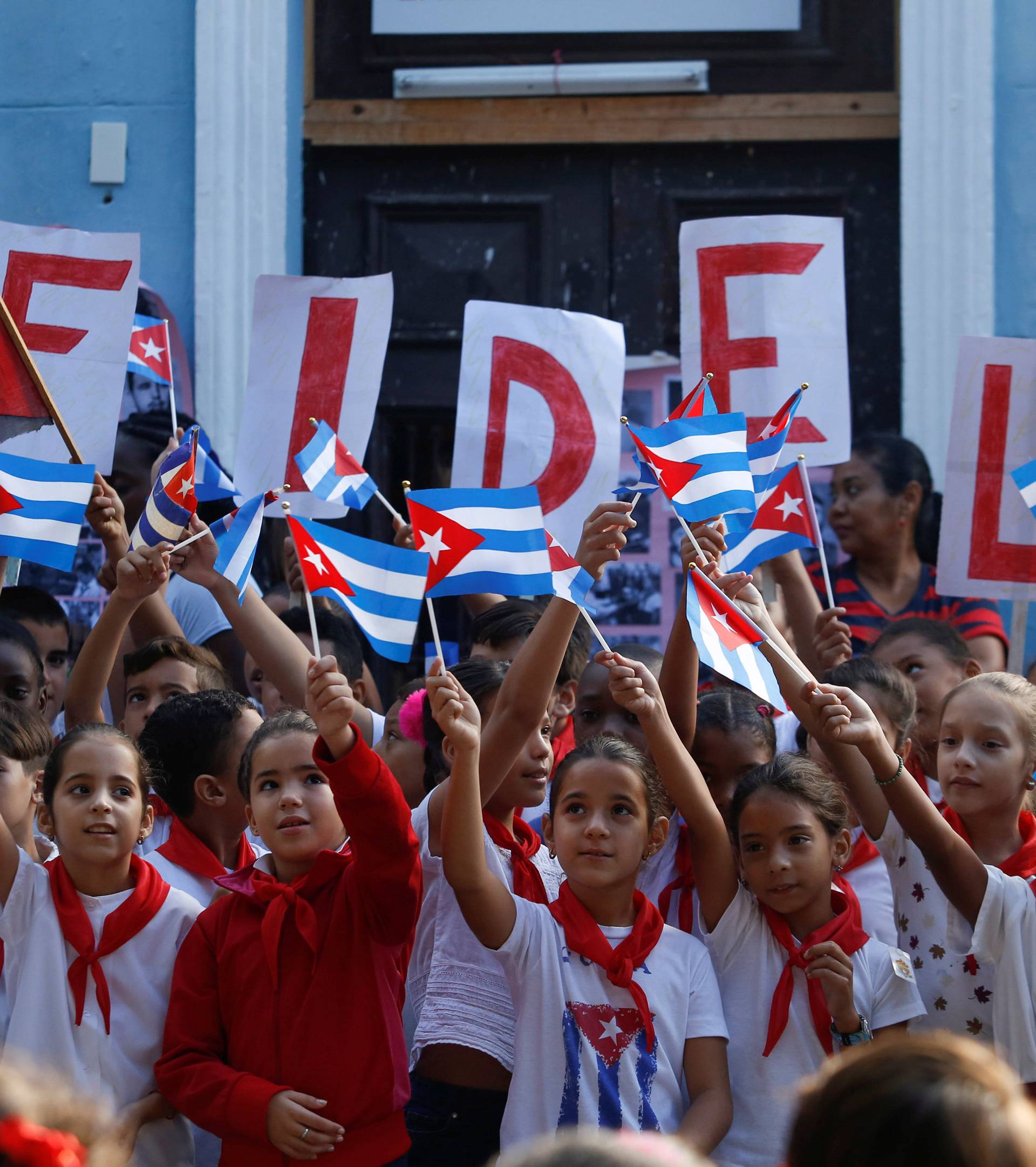 Children perform an act in a school to commemorate the first anniversary of the death of Cuba's late president Fidel Castro, in Havana