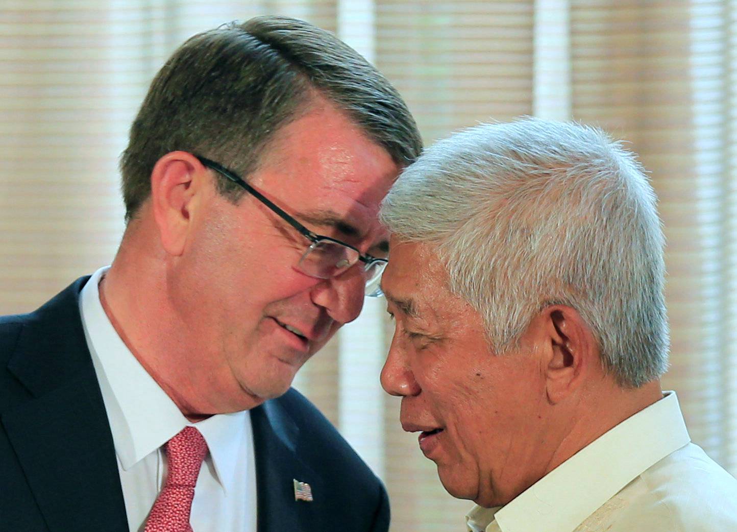 Filipino Defense Secretary Voltaire Gazmin talks to visiting U.S. Defense Secretary Ash Carter during their joint news conference at the presidential palace in Manila  
