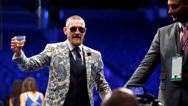 UFC lightweight champion Conor McGregor of Ireland leaves post-fight news conference at T-Mobile Arena in Las Vegas