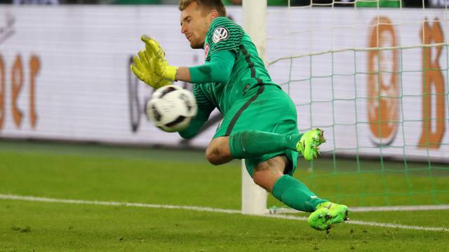 Eintracht Frankfurt's Lukas Hradecky saves a penalty taken by Borussia Monchengladbach's Andreas Christensen during the penalty shootout