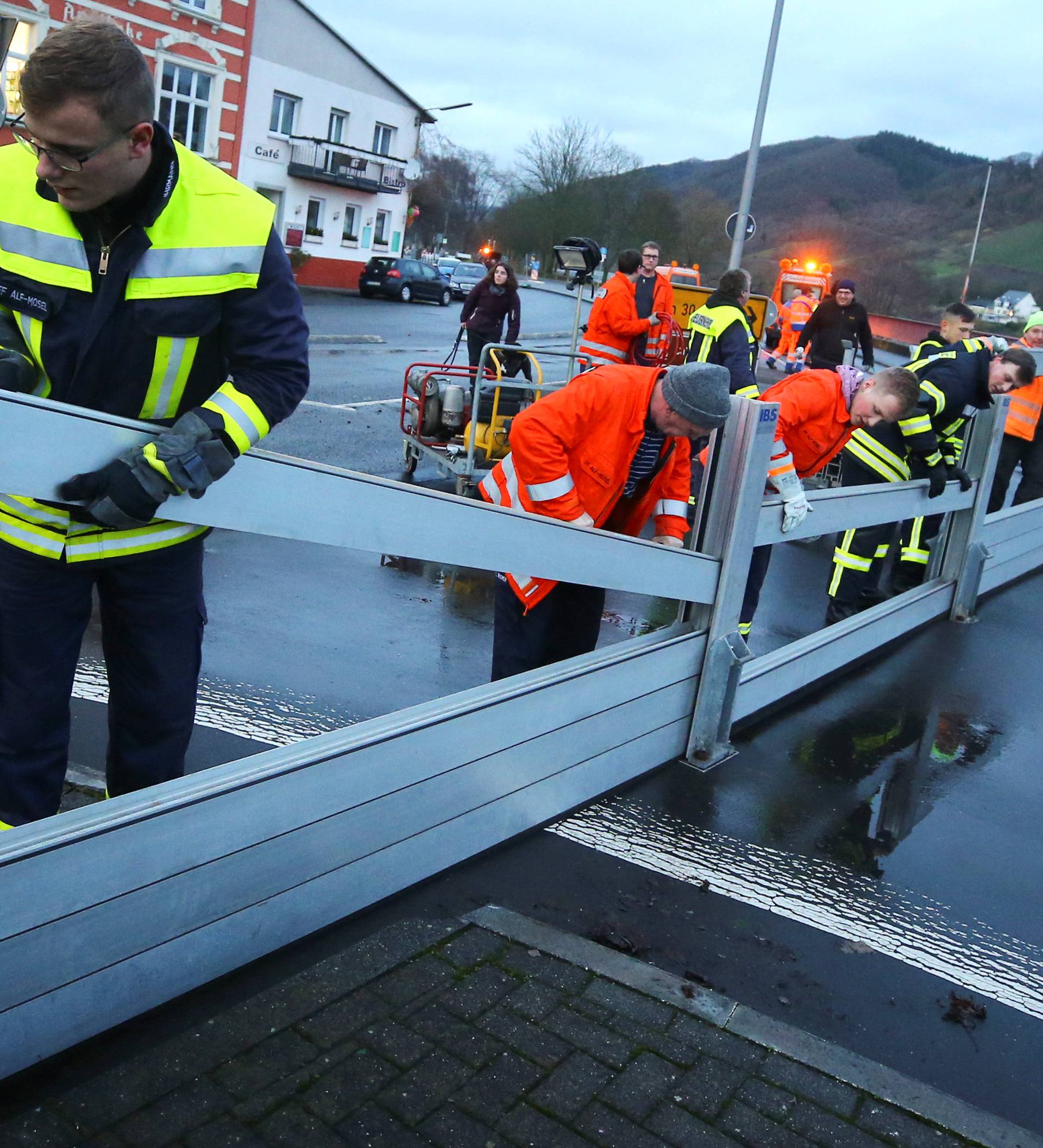 Firefighters set up a protection wall against the rising floods of the Moselle river to protect the little village of Alf