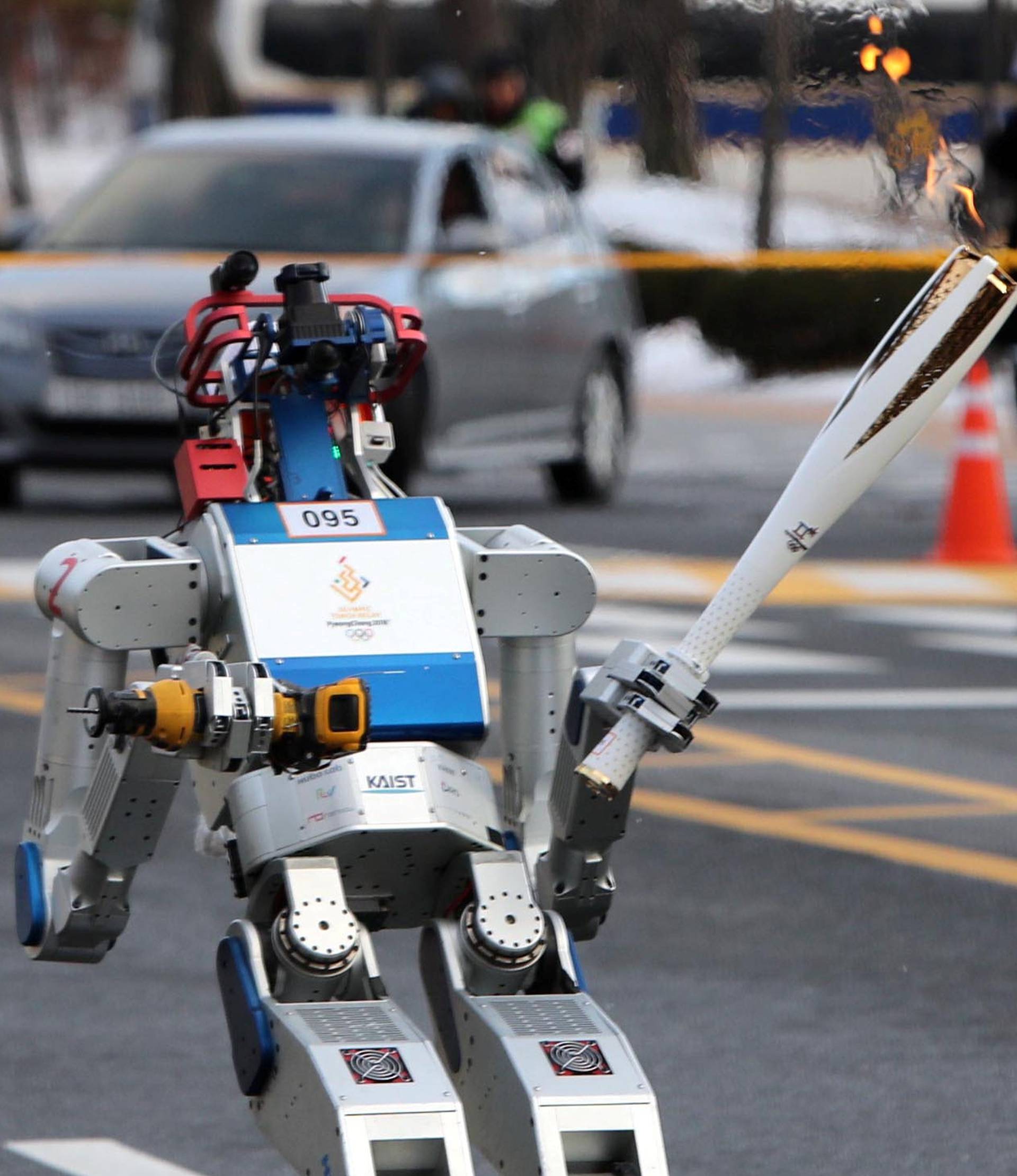 HUBO, a multifunctional walking humanoid robot, carries the Olympic torch at the Korea Advanced Institute of Science and Technology (KAIST) in Daejeon