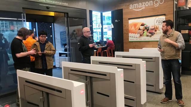 Shoppers enter the Amazon Go store located in Amazon's "Day 1" office building in Seattle