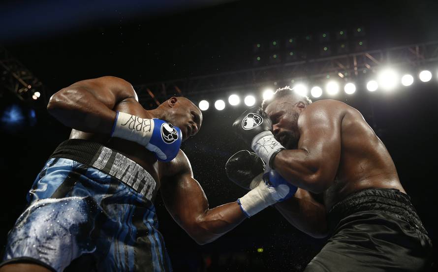 Dereck Chisora in action against Dillian Whyte (L)