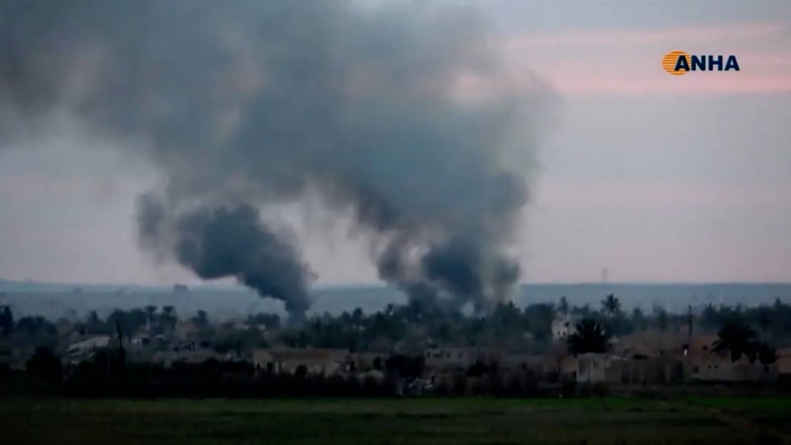 Smoke rises from a village near Baghouz