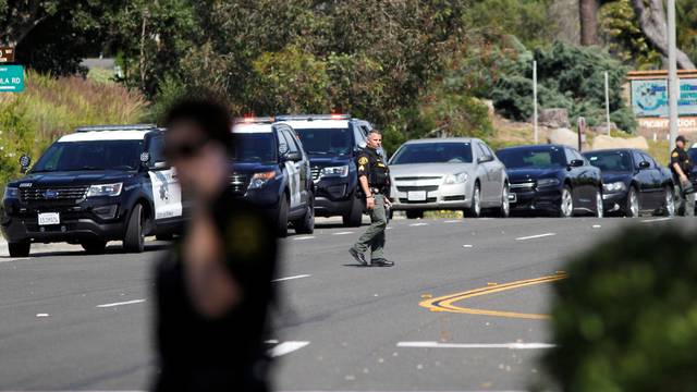 Police secure the scene of a shooting incident at the Congregation Chabad synagogue in Poway