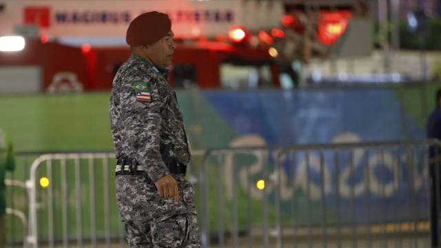 Police officer stands guard outside Carioca 1 during a suspicious package investigation in Rio de Janeiro