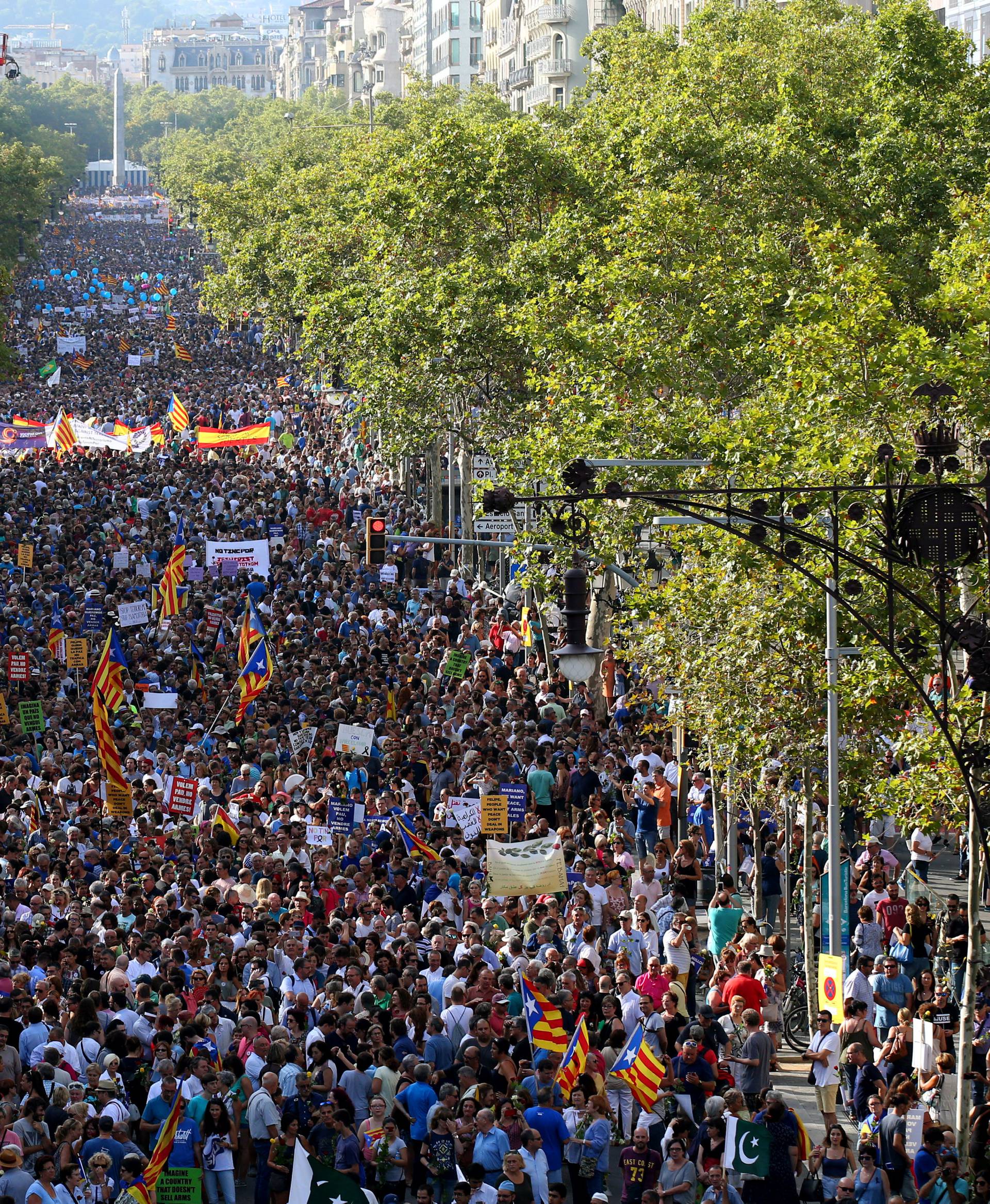 People hold placards and flags as they take part in a march of unity after the attacks last week, in Barcelona, Spain