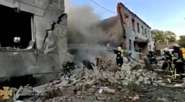 Firefighters spray water onto fire in a destroyed building after a missile strike, in Odesa