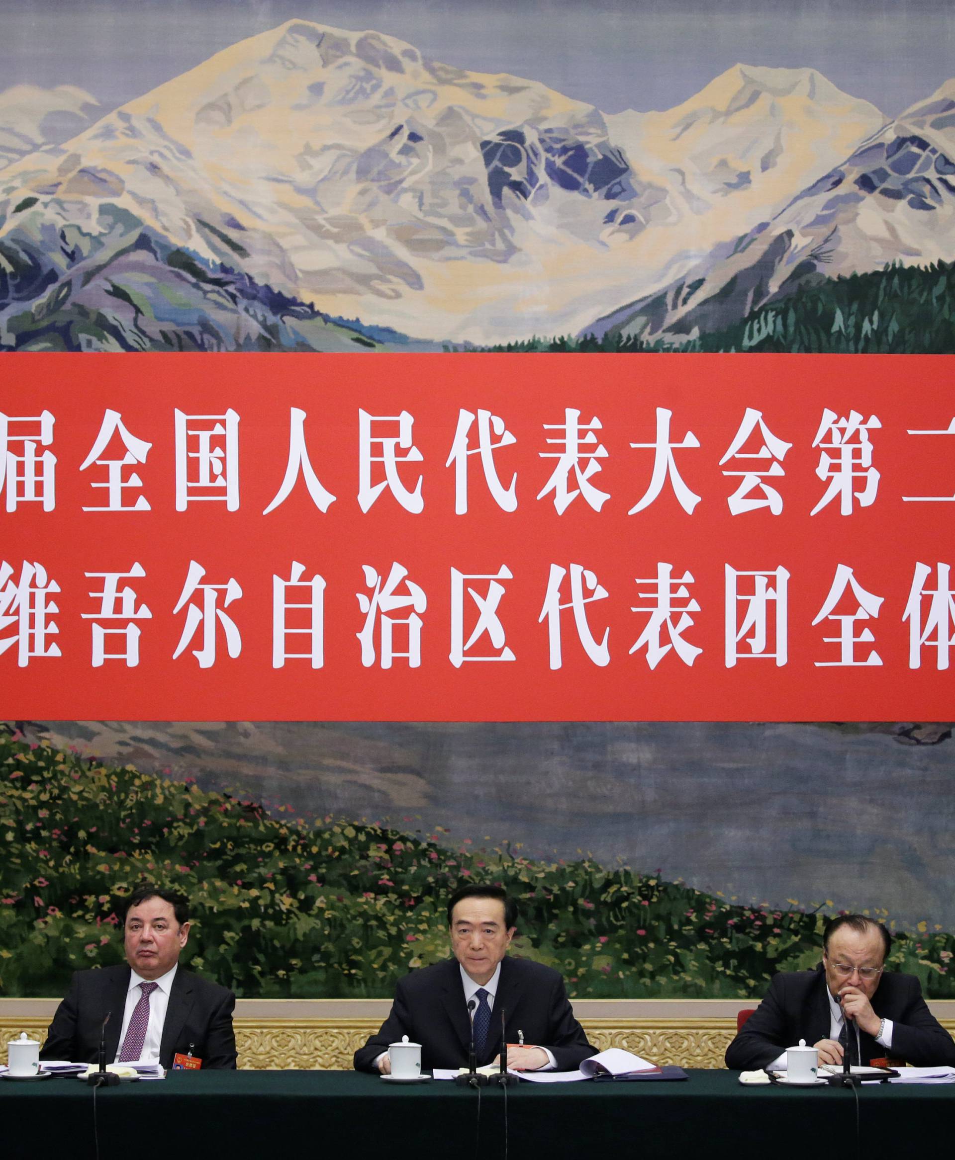 Officials attend the meeting of Xinjiang delegation on the sidelines of the National People's Congress (NPC), at the Great Hall of the People in Beijing