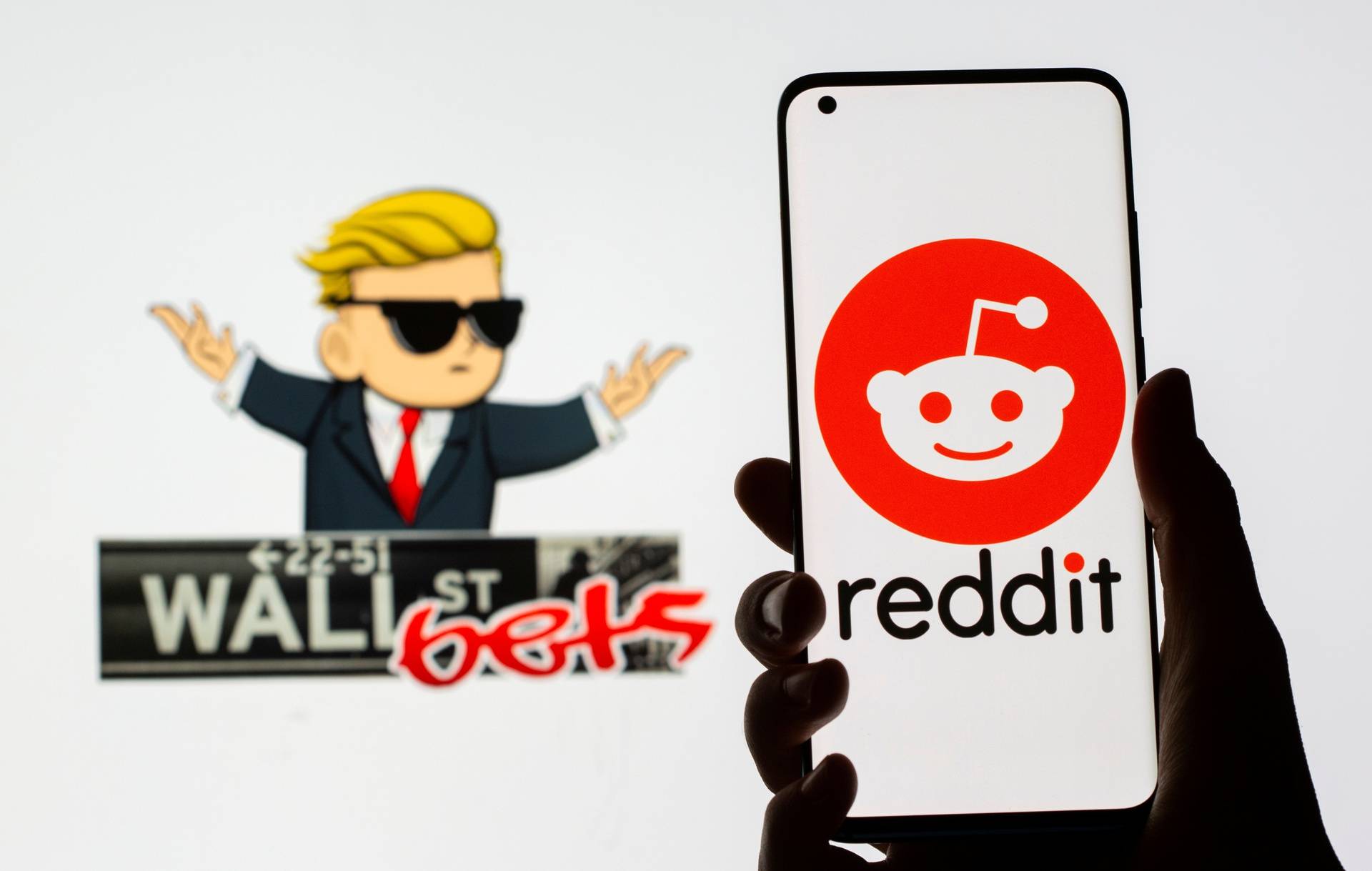 FILE PHOTO: The Reddit logo is seen on a smartphone in front of a displayed Wall Street Bets logo in this illustration