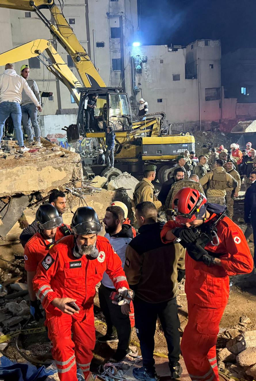 Rescue teams search for survivors after a building collapsed in Tripoli