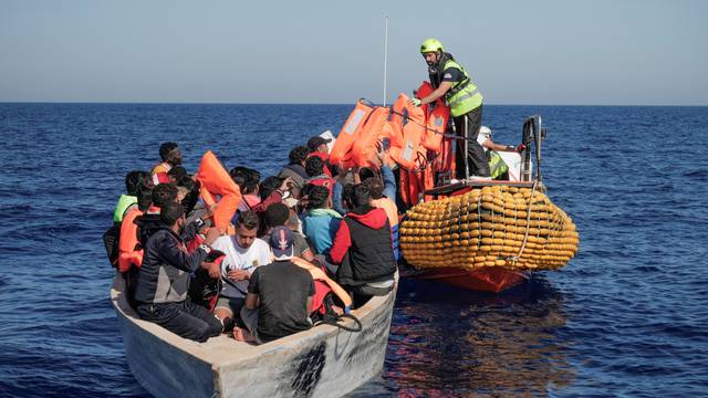 Crew members of NGO rescue ship 'Ocean Viking' give lifejackets to migrants in the Mediterranean Sea
