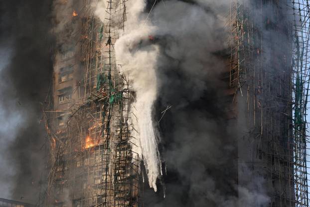 Flames engulf bamboo scaffolding across multiple buildings at Wang Fuk Court housing estate, in Tai Po