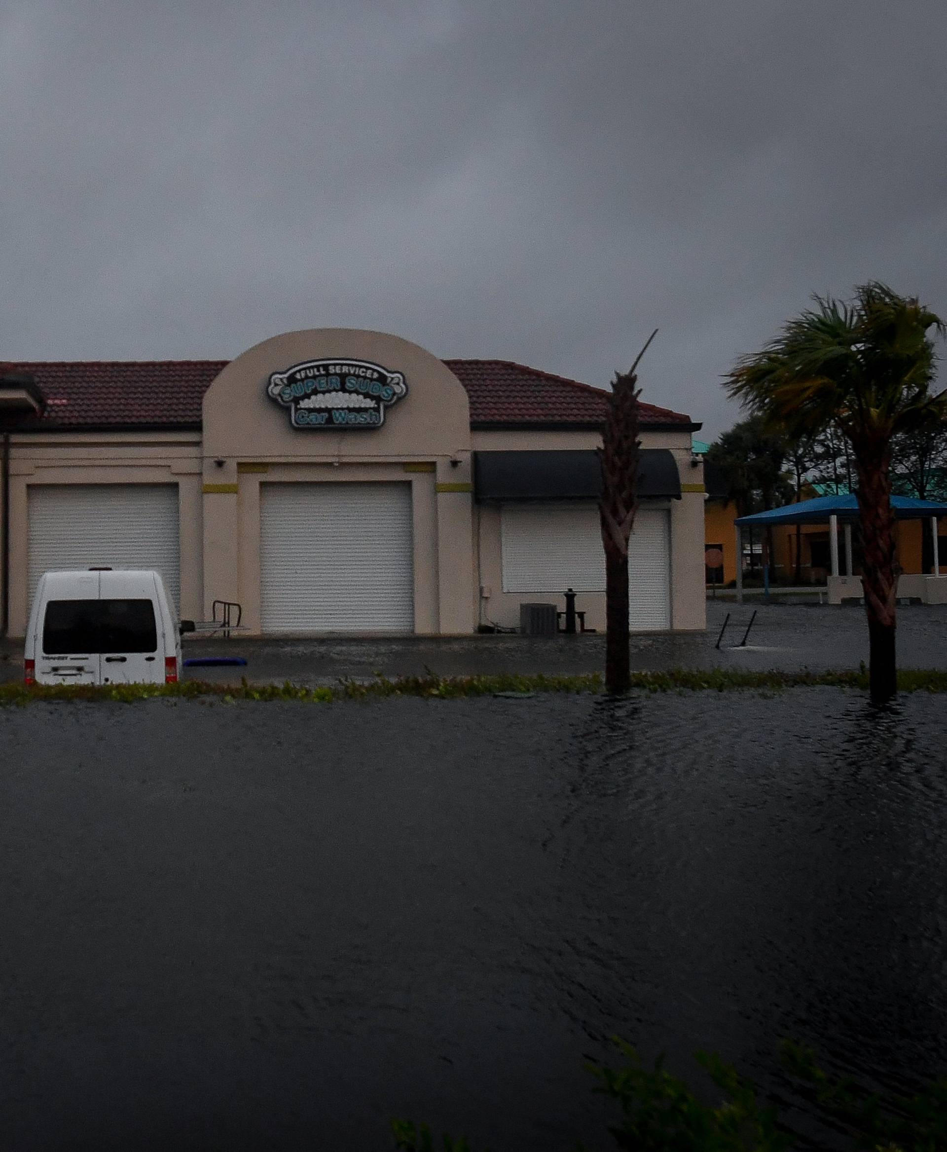 Floodwater from Hurricane Irma surrounds a car wash in Bonita Springs