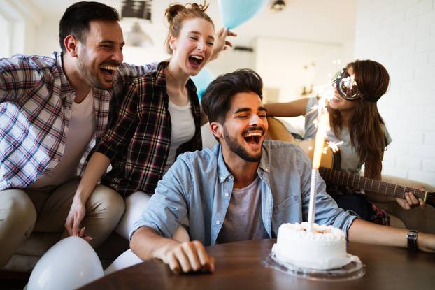Cheerful young friends having fun on party