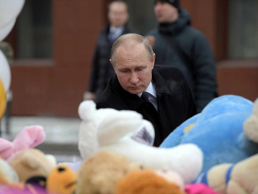 Russian President Vladimir Putin visits the site of fire, that killed at least 64 people at a busy shopping mall, in Kemerovo