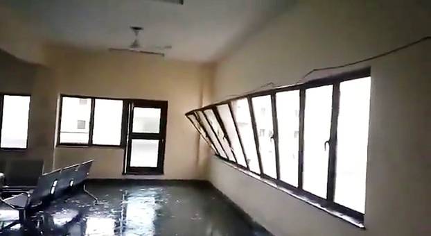 A strong wind blows a glass window into a building during Cyclone Fani in Bhubaneswar, Odisha