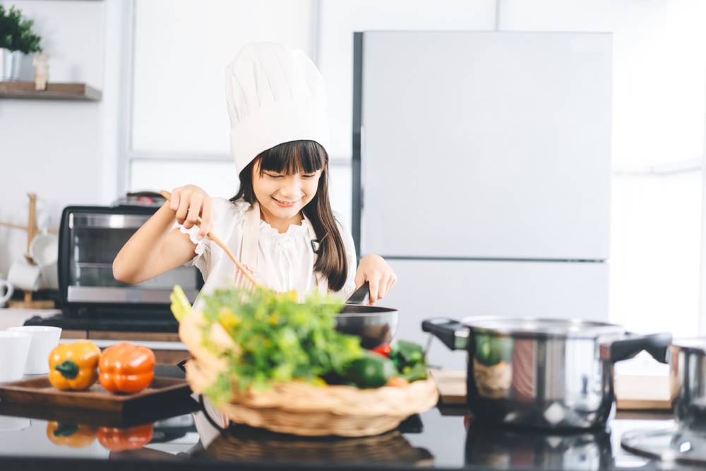 Little,Asian,Girl,With,Chef,Hat,And,Apron,Cooking,In