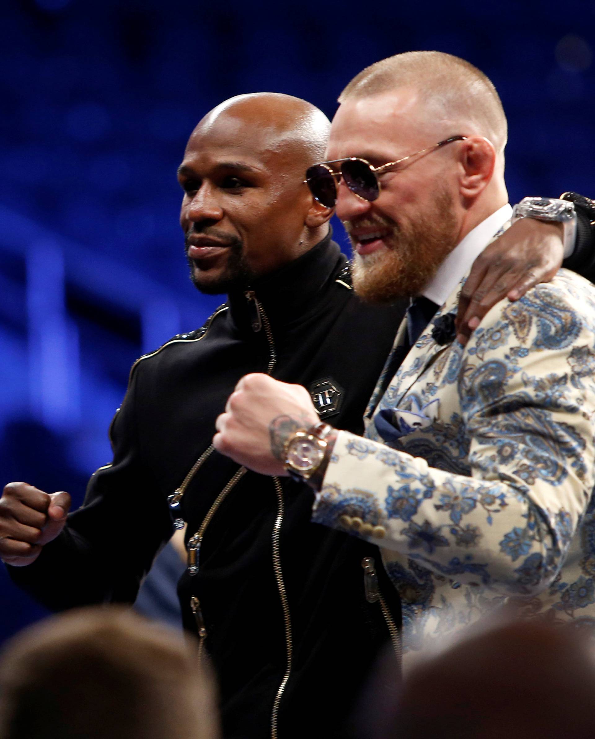Undefeated boxer Floyd Mayweather Jr. (L) of the U.S. and UFC lightweight champion Conor McGregor of Ireland pose during post-fight news conference at T-Mobile Arena in Las Vegas