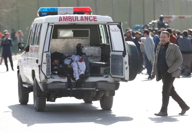 Victims are carried away in an ambulance after a blast in Kabul