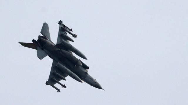 Israeli Air Force F-16 fighter jet flies near the Israeli border with Gaza as seen from Ashkelon