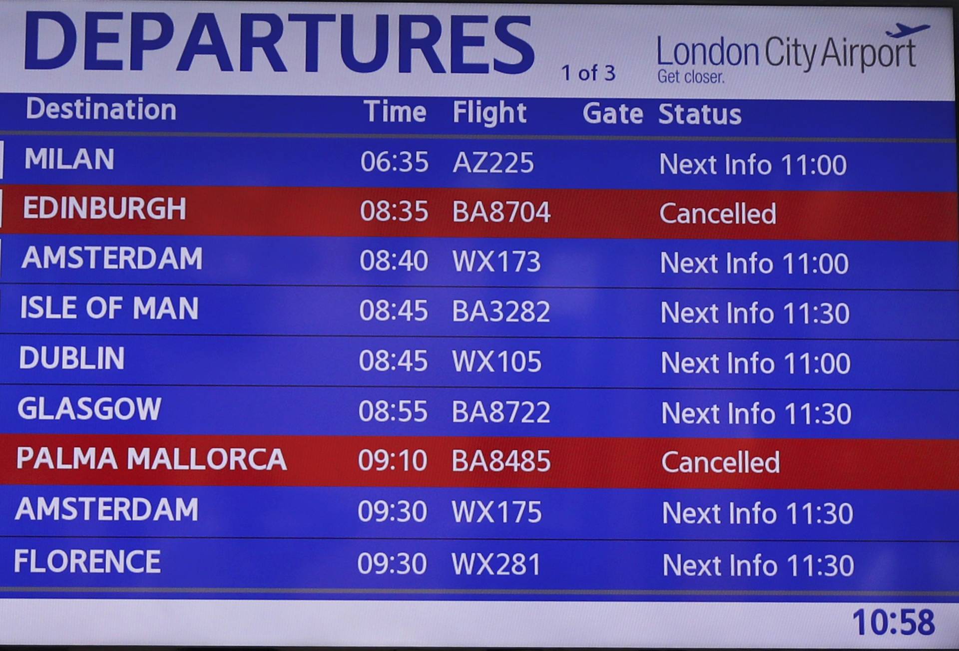 An information screen lists cancelled and delayed flights at City Airport after a protest closed the runway in London