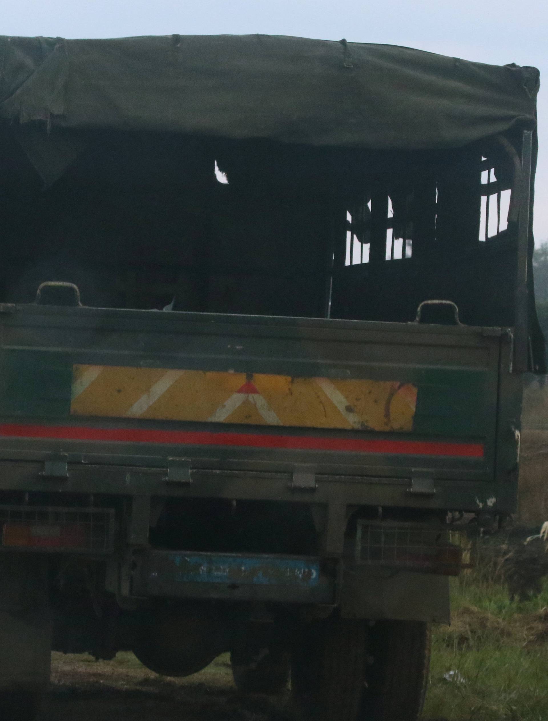 Soldiers stand beside military vehicles just outside Harare,Zimbabwe