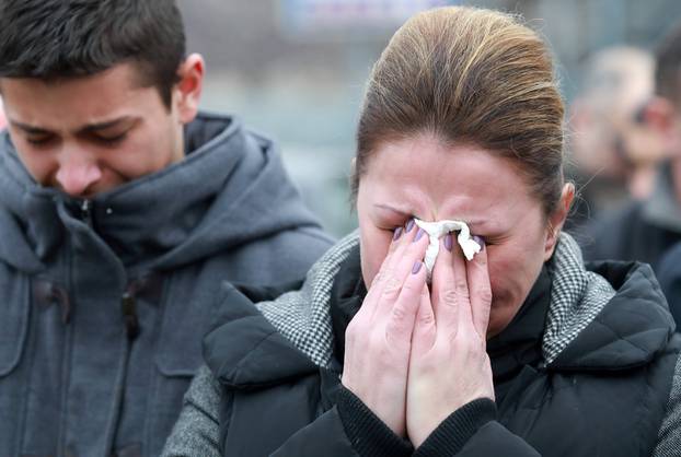 Mourners cry as a cortege escorts a car carrying coffin of Oliver Ivanovic travels to the northern outskirts of Kosovska Mitrovica