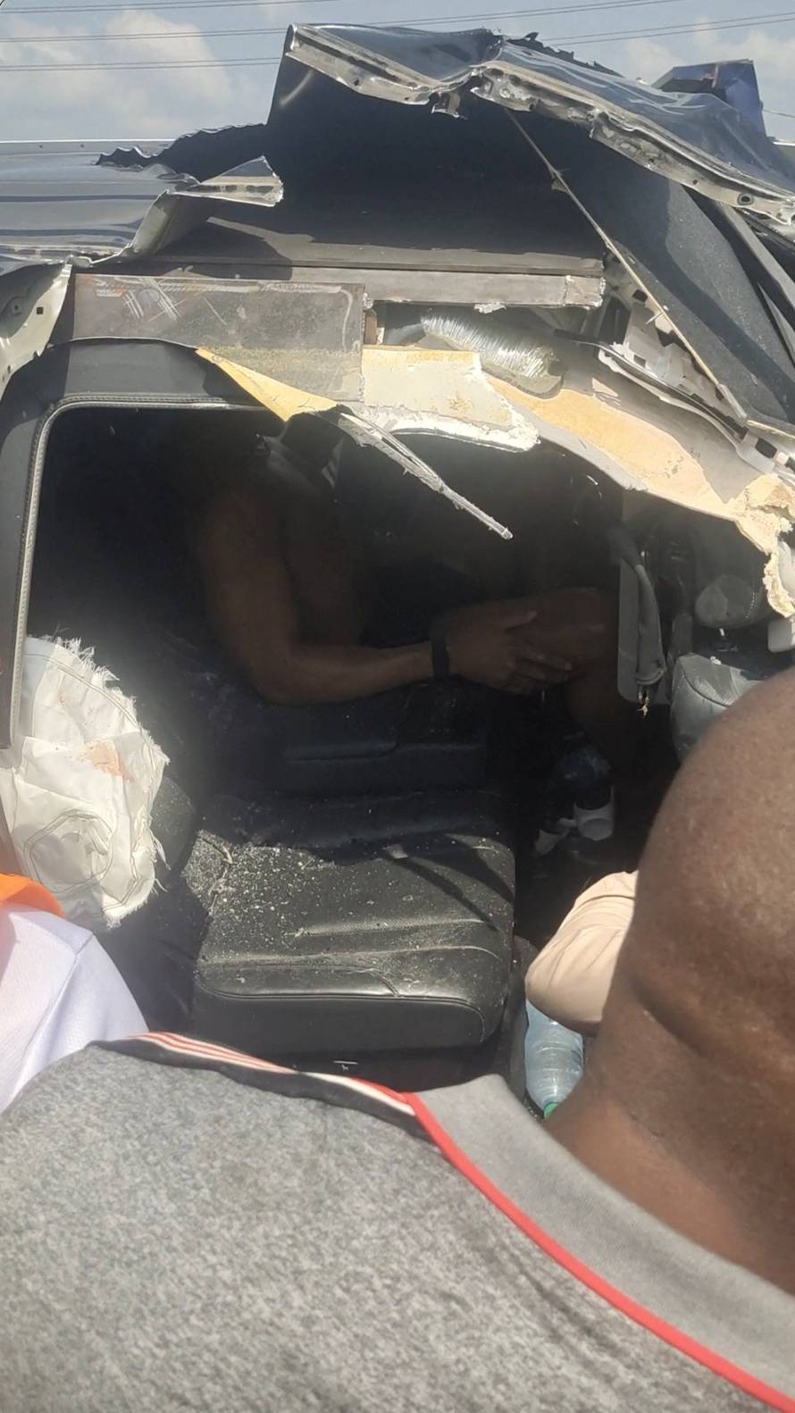 British boxer Anthony Joshua sits in a car after being involved in a car crash in Nigeria's Ogun State