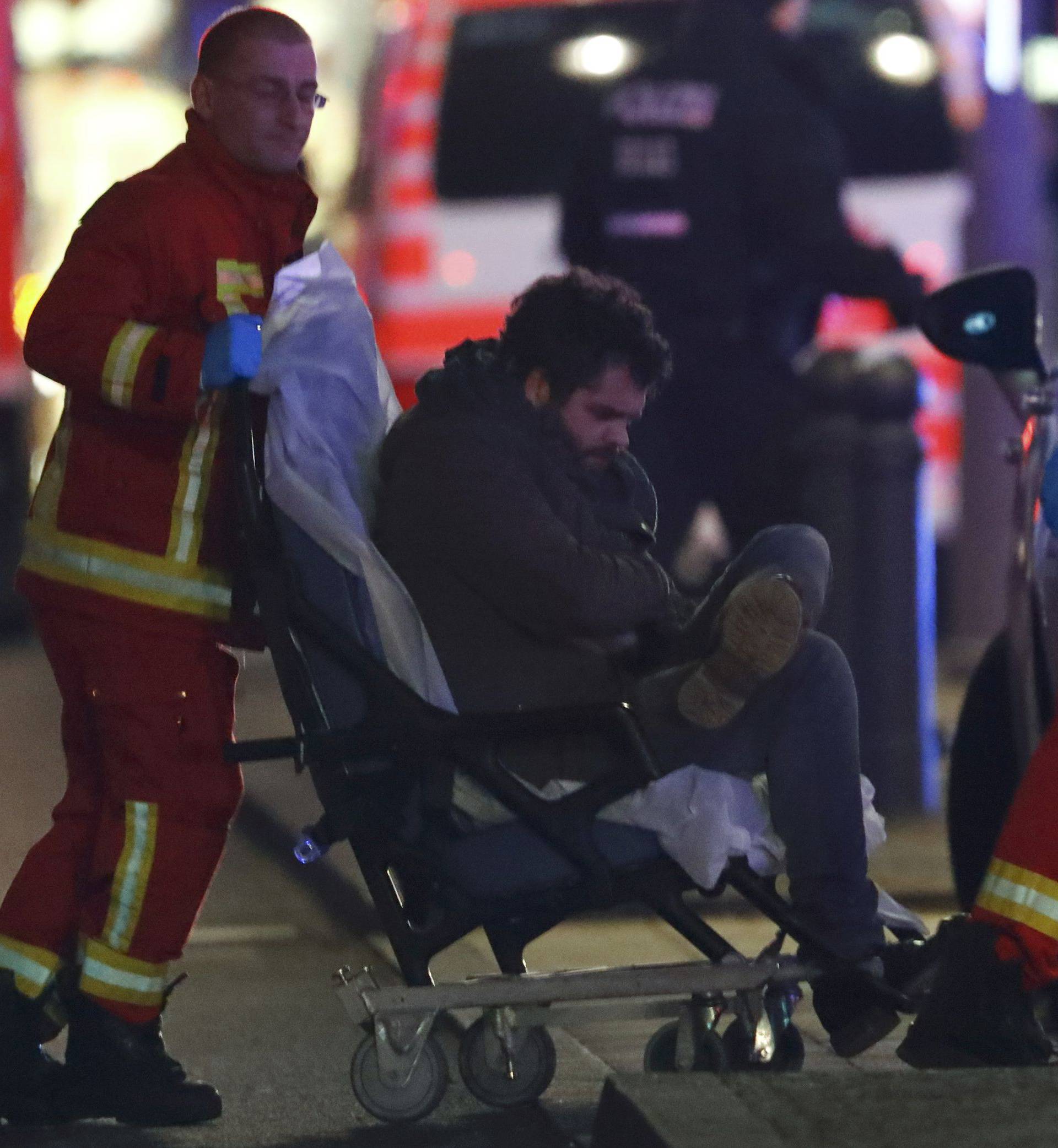 An injured man receives help near a Christmas market in Berlin