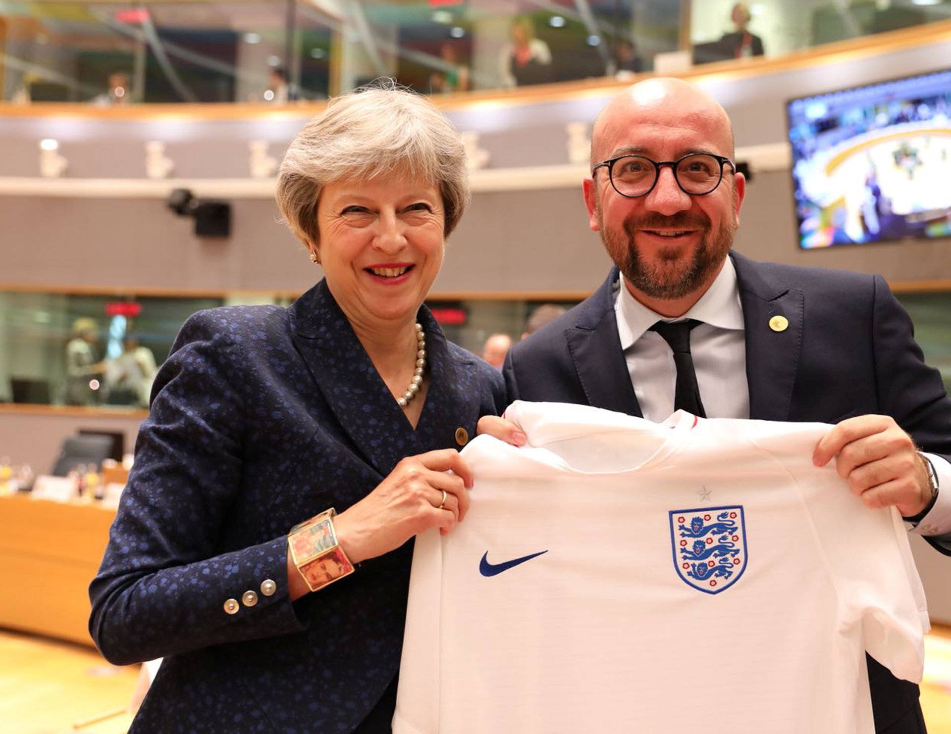 Belgian PM Michel receives England's national soccer team jersey from Britain's PM May as they attend an EU leaders summit in Brussels