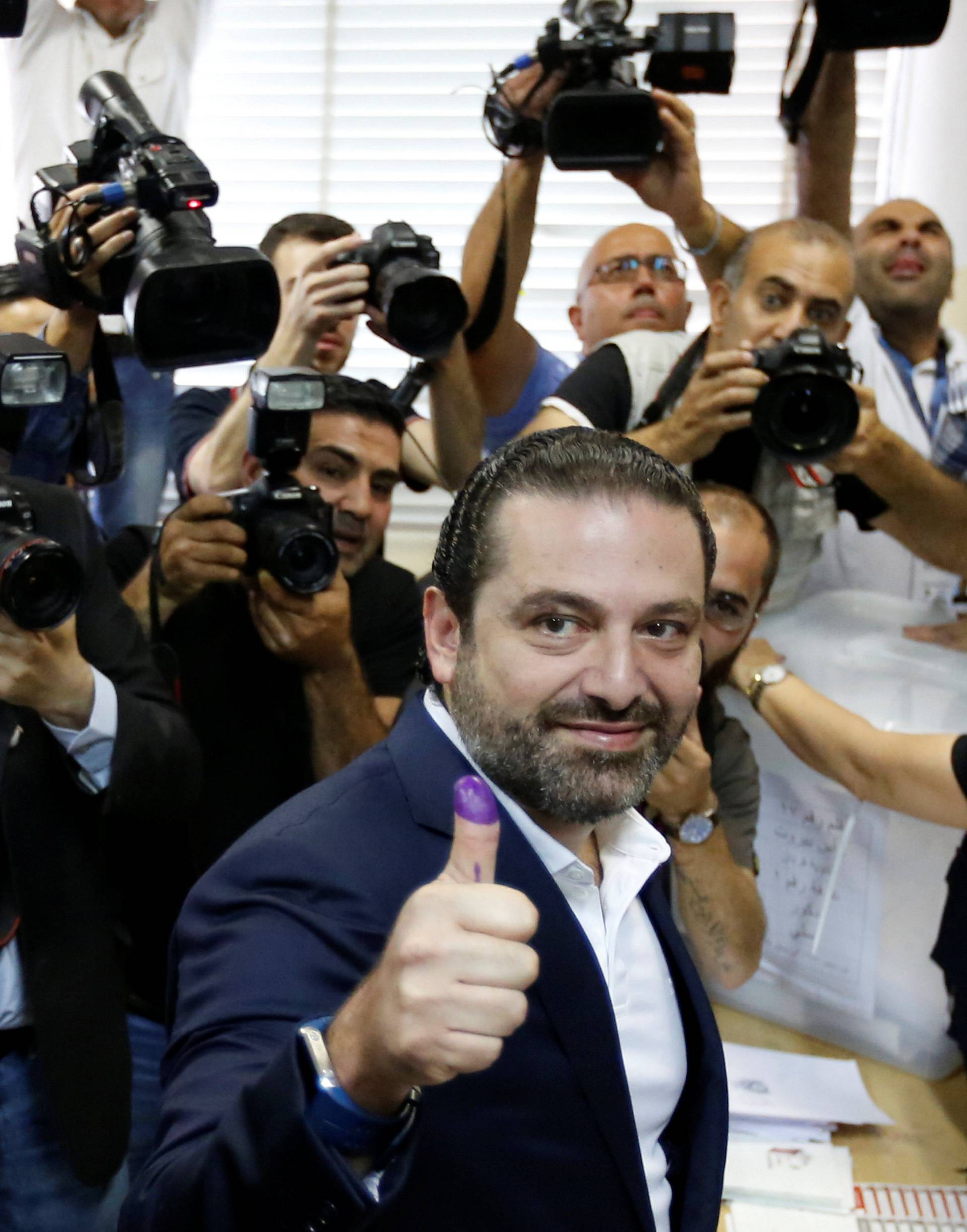 Lebanese prime minister and candidate for the parliamentary election Saad al-Hariri shows his ink-stained finger after casting his vote in Beirut
