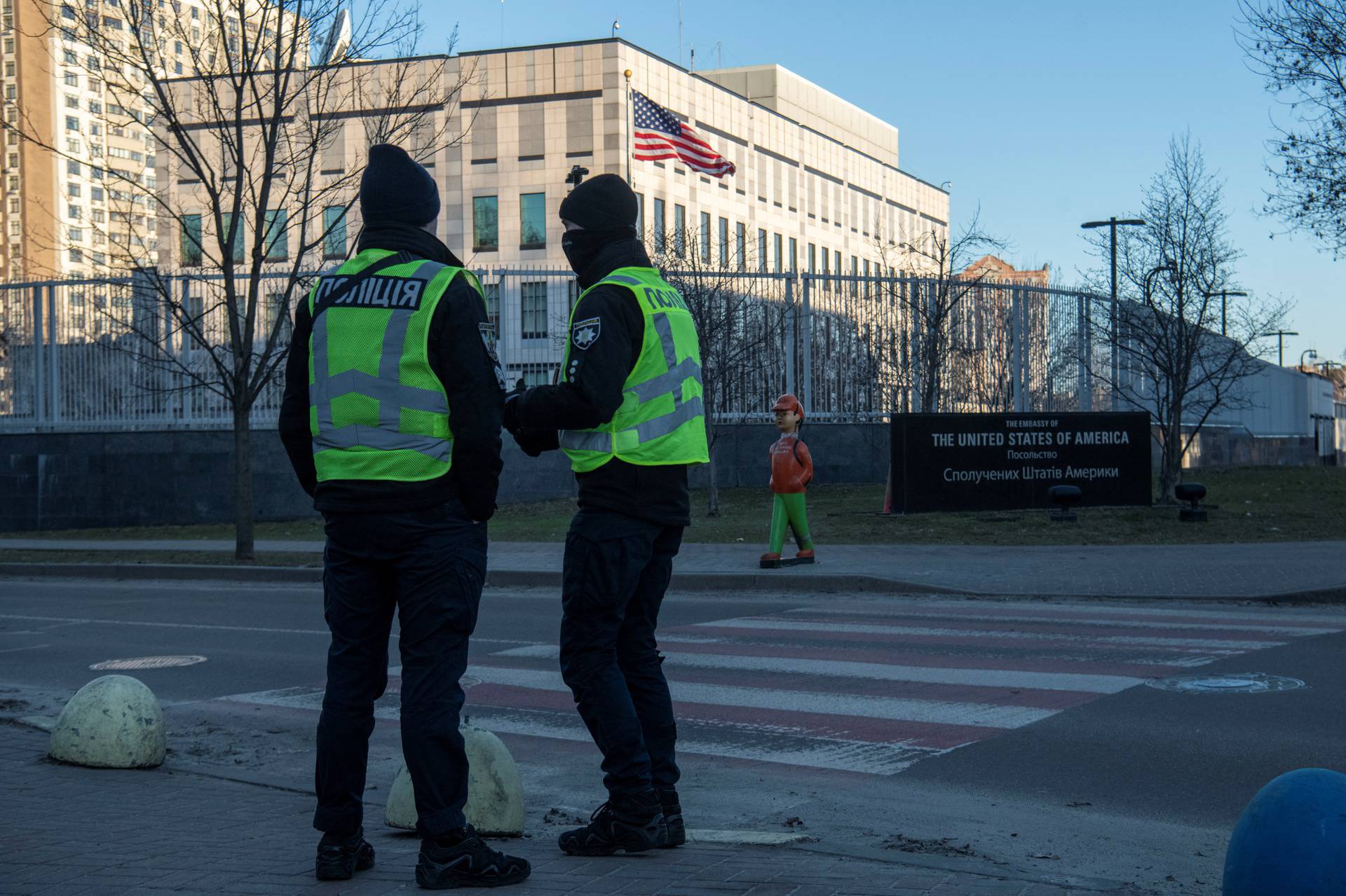 Police officers stand outside the U.S. embassy in Kyiv