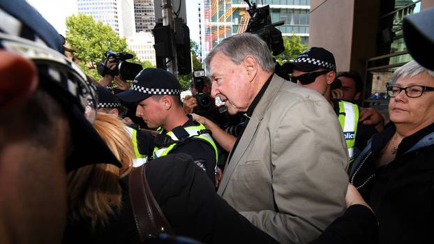 Cardinal George Pell departs the Melbourne Magistrates Court in Melbourne