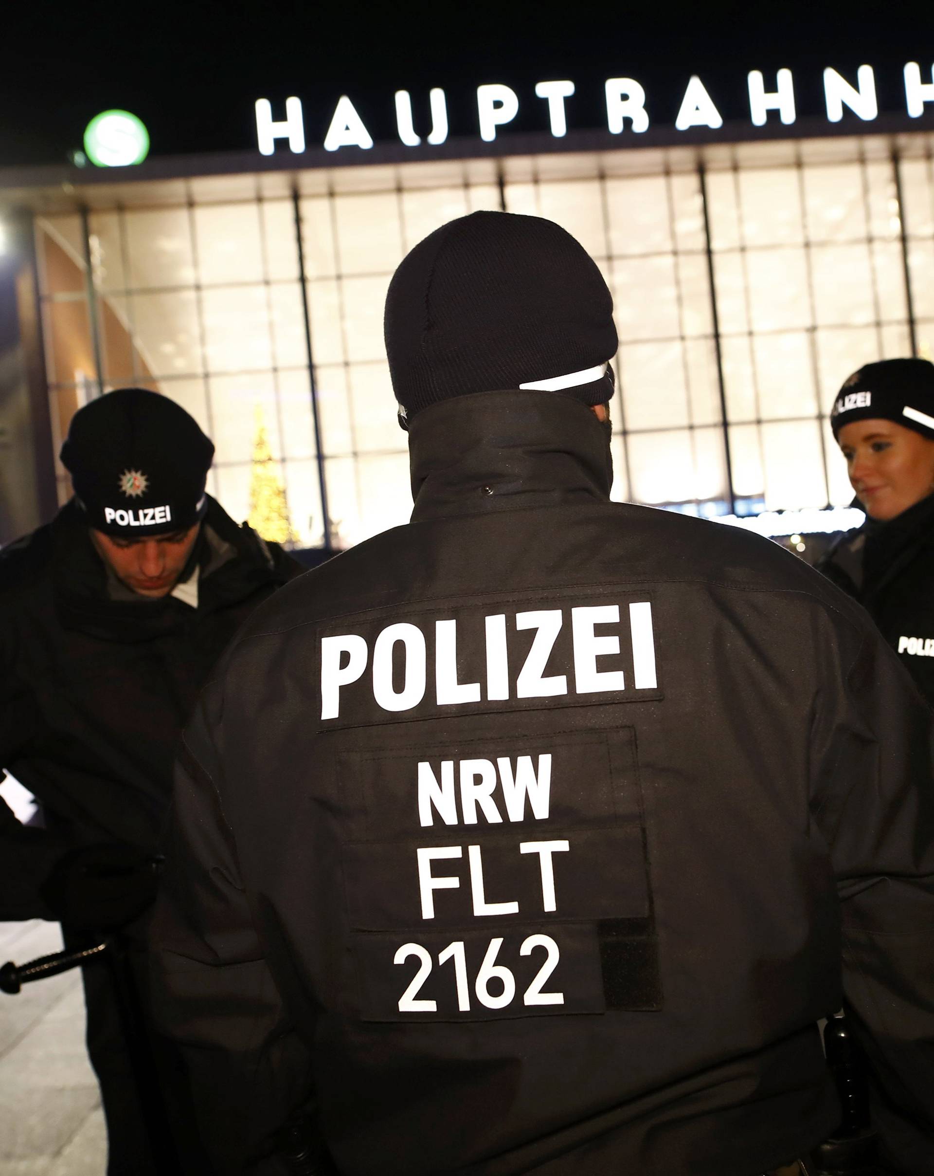 German police officers gather near the Hauptbahnhof before New Year celebrations for 2017 in Cologne