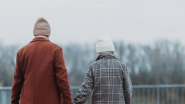 Rear,View,Of,Senior,Couple,Walking,Near,The,River,,During