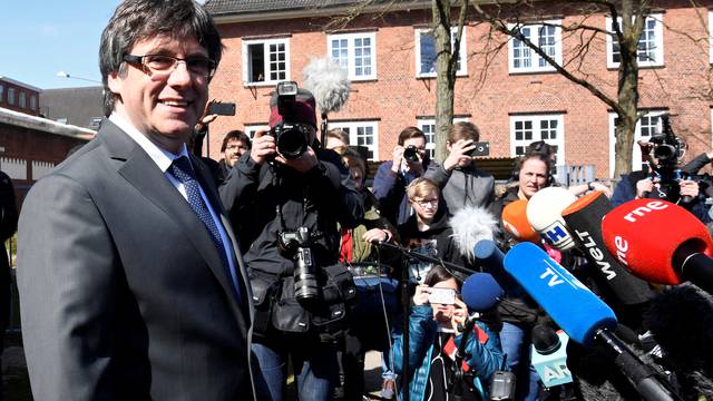 Catalonia's former leader Carles Puigdemont looks on as he leaves the prison in Neumuenster