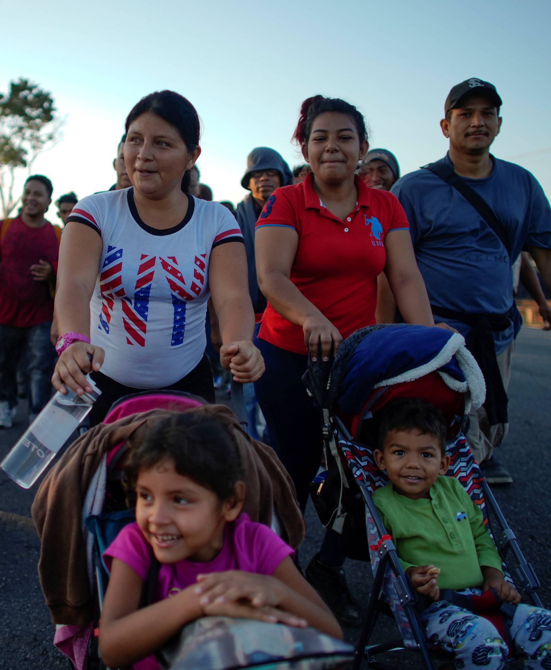 Migrant Celena Mejia, from Honduras, pushes a cart with her 6 year-old daughter during their journey towards the United States, in the outskirts of Ciudad Hidalgo, Mexico