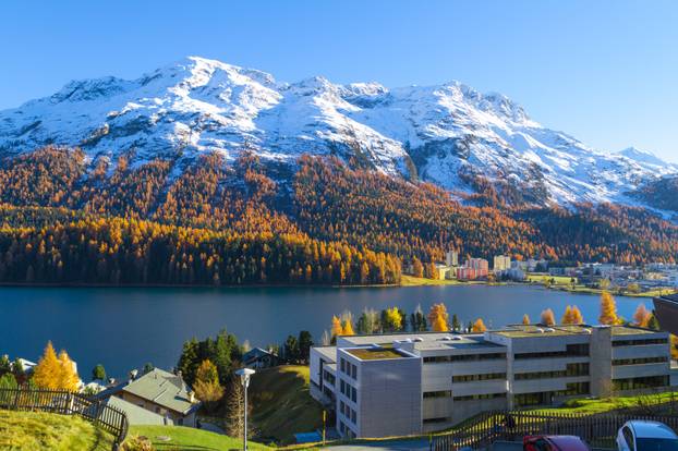 Panoramic view of St. Moritz Lake and snow-covered mountain.